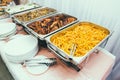 Cuisine Culinary Buffet Dinner Dining Food Celebration Party Concept. Trays with main meals - french fries chips, rice Royalty Free Stock Photo