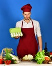 Cuisine and professional cooking concept. Man in cook uniform Royalty Free Stock Photo