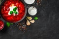 Culinary background with beetroot soup, sour cream and basil on a black concrete background Royalty Free Stock Photo