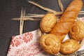 Culinary background with bread,sweet bun,wheat ears, on a black background, top view Royalty Free Stock Photo