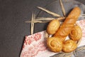 Culinary background with bread,sweet bun,wheat ears, on a black background, top view Royalty Free Stock Photo