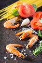 Culinary background for cooking with pasta, shrimps, tomatoes, fresh herbs and spices