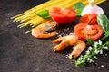 Culinary background for cooking with pasta, shrimps, tomatoes, fresh herbs and spices.