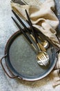 Culinary background with empty plate spoon fork and knife on a slate, stone or concrete table. Royalty Free Stock Photo