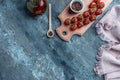 Culinary background with empty wooden cutting board, composition of oil, chili peppers, cherry tomatoes sprig and spices. banner, Royalty Free Stock Photo