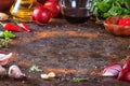 Culinary background with kitchen stone surface, olive oil in a jug and vegetables.