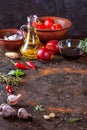 Culinary background with kitchen stone surface, olive oil in a jug and vegetables. Empty space for menu or recipe