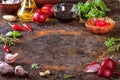 Culinary background with kitchen stone surface, olive oil in a jug and vegetables.