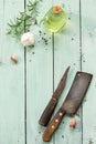 Culinary background. Vintage kitchen utensils, olive oil, garlic and rosemary on a wooden kitchen table. Royalty Free Stock Photo