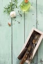 Culinary background. Vintage kitchen utensils, olive oil, garlic and rosemary on a wooden kitchen table. Royalty Free Stock Photo