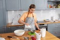 woman cooking food and baking on kitchen at home