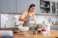 woman cooking food and baking on kitchen at home