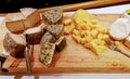 Culinary cheese platter assortment served on a wooden board