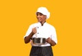 Culinary Concept. Black Chef Woman Cooking Food In Saucepan Over Yellow Background Royalty Free Stock Photo