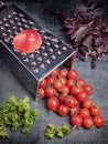 Preparation recipe tomato juice. Large tomato and old grater down to small grape cherry tomatoes on retro vintage rustic gray ston Royalty Free Stock Photo