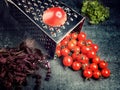 Preparation recipe tomato juice. Large tomato and old grater down to small grape cherry tomatoes on retro vintage rustic gray ston Royalty Free Stock Photo