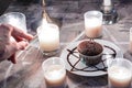 Culinary concept `Summon Chocolate Muffin` Candles, gray background and pentagram on a white plate