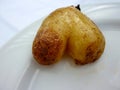 A Culinary Delight: Heart-Shaped Roasted Potatoes on a White Plate, a Whimsical Creation by Nature