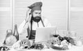 Culinary education online. Elearning concept. Man chef searching internet recipe cooking food. Chef laptop read culinary Royalty Free Stock Photo