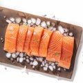 Culinary elegance Portioned salmon fillets on ice with an empty board