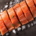 Culinary elegance Salmon fillets portioned on ice, clean kitchen board