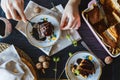 A culinary girl is decorating a delicious piece of freshly baked cake with chocolate