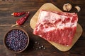 Culinary ingredients: raw pork belly, red beans, garlic, peppercorns, hot peppers Royalty Free Stock Photo