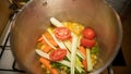 Culinary preparation based on vegetables and spices, simmering in a steel casserole dish