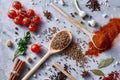 Culinary still life of assorted spices on white textured background, flat lay, close-up, selective focus. Royalty Free Stock Photo