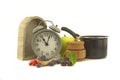 Culinary still life with clock, pot and berries