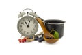 Culinary still life with clock, pot and berries