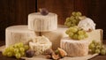 Culinary Still Life with Creamy Wheels, Grapes, and Figs on a Textured Surface. Royalty Free Stock Photo