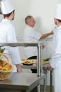 Culinary students learning how to mix dough in kitchen