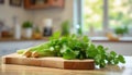 A selection of fresh herbs: coriander leaves, sitting on a chopping board against blurred kitchen background copy space