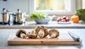 A selection of fresh vegetable: maitake mushroom, sitting on a chopping board against blurred kitchen background copy space