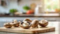 A selection of fresh vegetable: portobello mushroom, sitting on a chopping board against blurred kitchen background copy space