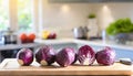 A selection of fresh vegetable: red cabbage, sitting on a chopping board against blurred kitchen background copy space Royalty Free Stock Photo