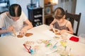 Culinary workshops. Children decorating gingerbread cookies with glaze on table