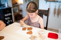 Culinary workshops for children and gingerbread decorating. Young girl decorating gingerbread cookies