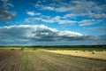 Cultivated fields in eastern Poland, horizon and clouds on the sky Royalty Free Stock Photo