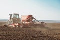 Cultivating tractor in the field. Farmer plowing the field. Royalty Free Stock Photo