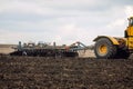 Cultivation of the soil with a disc harrow attached to a tractor Royalty Free Stock Photo