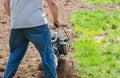 Cultivator for tillage in the garden,motor cultivator. Man Farmer plows the land with a cultivator