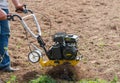 Cultivator for tillage in the garden,motor cultivator. Man Farmer plows the land with a cultivator