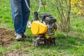 Cultivator for tillage in the garden,motor cultivator. Man Farmer plows the land with a cultivator