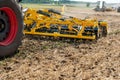 Close up of a disc harrow. cultivator at work on a field background Royalty Free Stock Photo