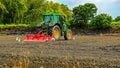 Cultivators and egrets in ploughing fields