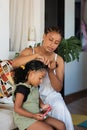 Cultural Closeness. Colombian Love. Mom combs her daughter's hair