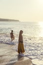 Cultural contrast. One woman in bikini and one woman wearing muslim clothes. Uluwatu, Indonesia.