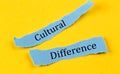 CULTURAL DIFFERENCE text on a blue pieces of paper on yellow background, business concept